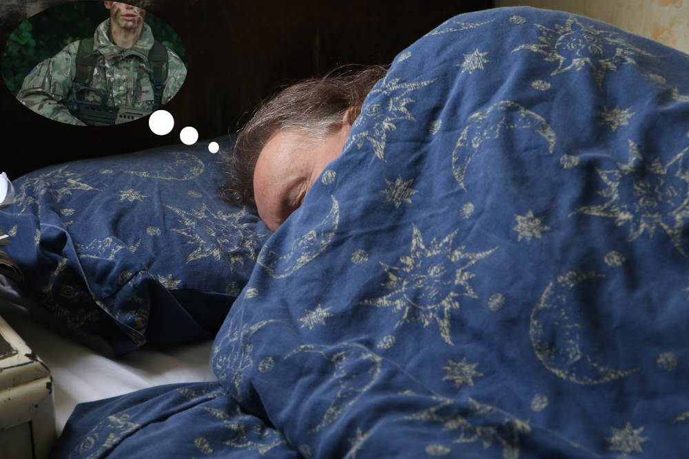 Man in bed. Dream bubble showing soldier.